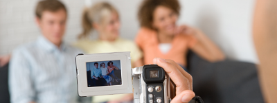 Three people being filmed with a handheld camera