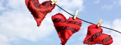 Three heart shaped cushions pegged on a line