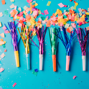 Party blowers lined up with confetti around