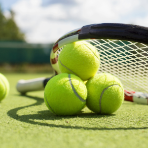 Tennis balls with a racket balanced on top